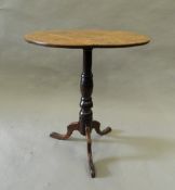 A 19th century oak and fruitwood tripod table. 60 cm diameter.