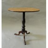 A 19th century oak and fruitwood tripod table. 60 cm diameter.