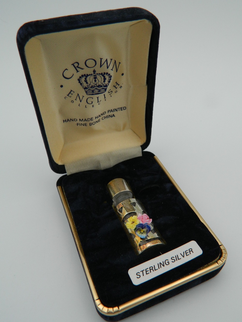 A silver miniature scent bottle, boxed. 4 cm high.