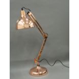 A copper angle poise lamp