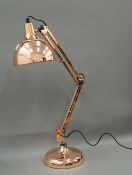 A copper angle poise lamp