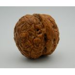 A Chinese carved walnut. 3.5 cm high.