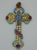 An enamelled decorated silver cross pendant, bearing Russian marks. 6 cm high.