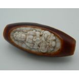 A carved Tibetan dzi bead. 5 cm high.