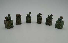 A set of six Chinese bronze seals, each set with an animal. The largest 4 cm high.