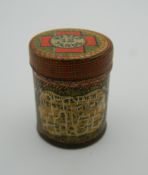 A wax dental floss tin. 3.5 cm high.