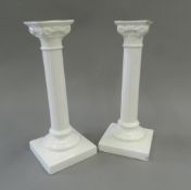 A pair of white porcelain Corinthian column candlesticks. 23 cm high.