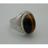 A silver and tiger eye ring.