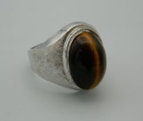 A silver and tiger eye ring.