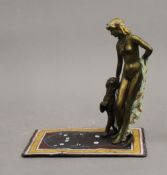 A cold painted bronze model of a girl and leopard