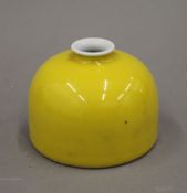 A Chinese yellow porcelain brush pot. 8.5 cm high.