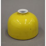 A Chinese yellow porcelain brush pot. 8.5 cm high.