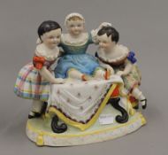 A Victorian porcelain figural group. 18 cm high.