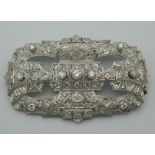 An Art Deco style platinum and diamond set brooch. 7 cm wide (21.