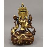 A finely cast part gilded and painted Tibetan copper figure of a seated deity. 22 cm high.