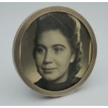 A silver circular photo frame. 9 cm diameter.