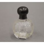A small silver topped glass scent bottle. 9 cm high.