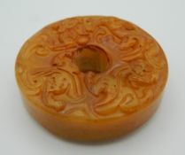 A Chinese toffee jade roundel. 5.5 cm diameter.