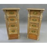 A pair of small banks of pine drawers with leather tops. 80.5 cm high.