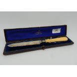 A Victorian ivory handled silver cake knife, cased.