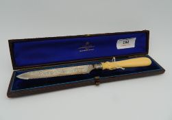 A Victorian ivory handled silver cake knife, cased.