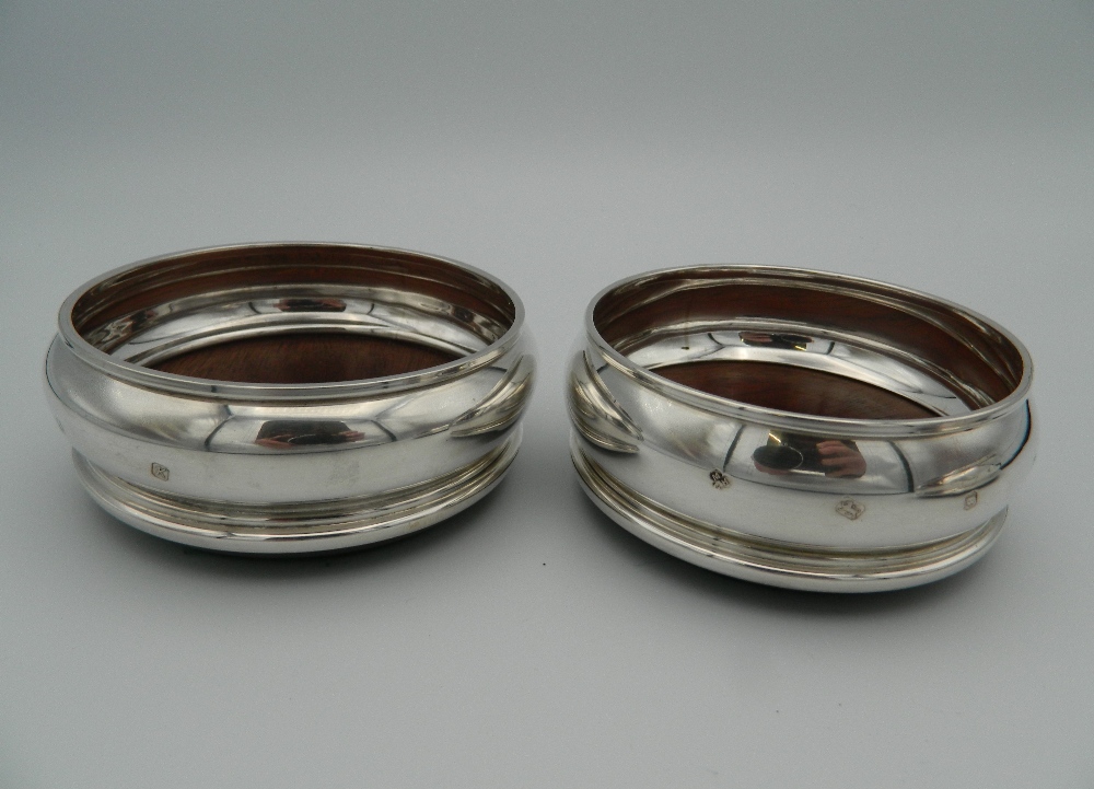 A trio of silver and wood coasters, - Image 2 of 4