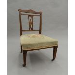 A tapestry covered Edwardian inlaid rosewood nursing chair. 50 cm wide.