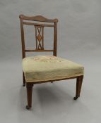 A tapestry covered Edwardian inlaid rosewood nursing chair. 50 cm wide.