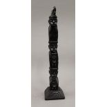 An Eastern carved wooden figural totem pole. 34.5 cm high.