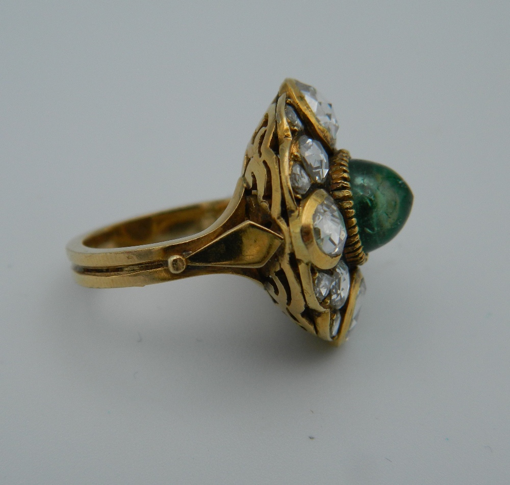 An unmarked 18 ct gold diamond and emerald ring. 2 cm diameter. Ring size I/J. - Image 2 of 4