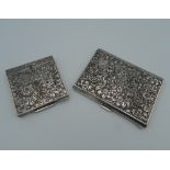 An 800 Continental silver compact of square form, heavily chased with flowers and scroll work,