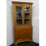 A 19th century glazed pine corner cabinet. 195 cm high.