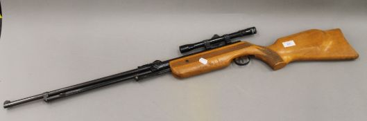 An air rifle, with scope. 112.5 cm long.