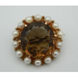 A 9 ct gold smoky quartz and pearl brooch. 2.5 cm diameter.