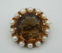 A 9 ct gold smoky quartz and pearl brooch. 2.5 cm diameter.