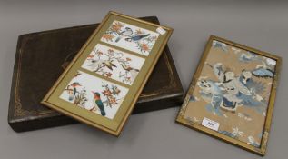 A cased set of Chinese place mats and two silk pictures. The case 40 cm wide.