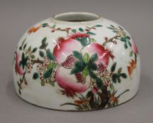 A Chinese porcelain brush washer decorated with peaches. 12.5 cm diameter.