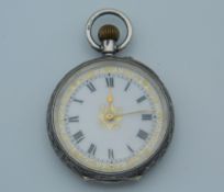 A silver fob watch with engraved case. 3 cm diameter.