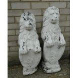 A pair of lion form garden statues. The largest 80 cm high.