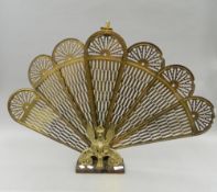 A brass folding fire screen in the form of a phoenix. 59 cm high.