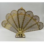 A brass folding fire screen in the form of a phoenix. 59 cm high.