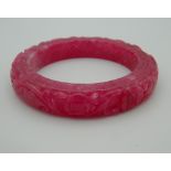 A pink jade bangle. 8 cm diameter.