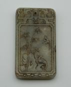 A rectangular jade pendant, decorated with calligraphy. 6 cm high.