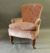 A Victorian button back armchair. 71 cm wide.