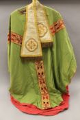 A green silk and gold embroidered cape and neck cloth