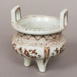 A Chinese porcelain censer Of typical squat circular form with twin loop handles,