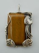 A silver tigers eye pendant. 6 cm high.