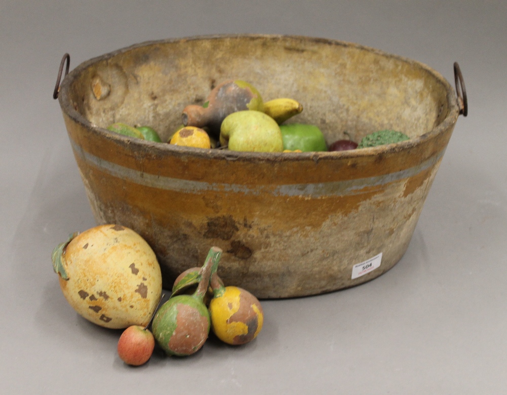 A 19th century papier mache footbath and a quantity of faux fruit. The former 43 cm wide.