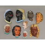 A collection of German pottery wall masks. The largest 24 cm high.