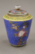 A Chinese porcelain lidded tea jar. 11.5 cm high.